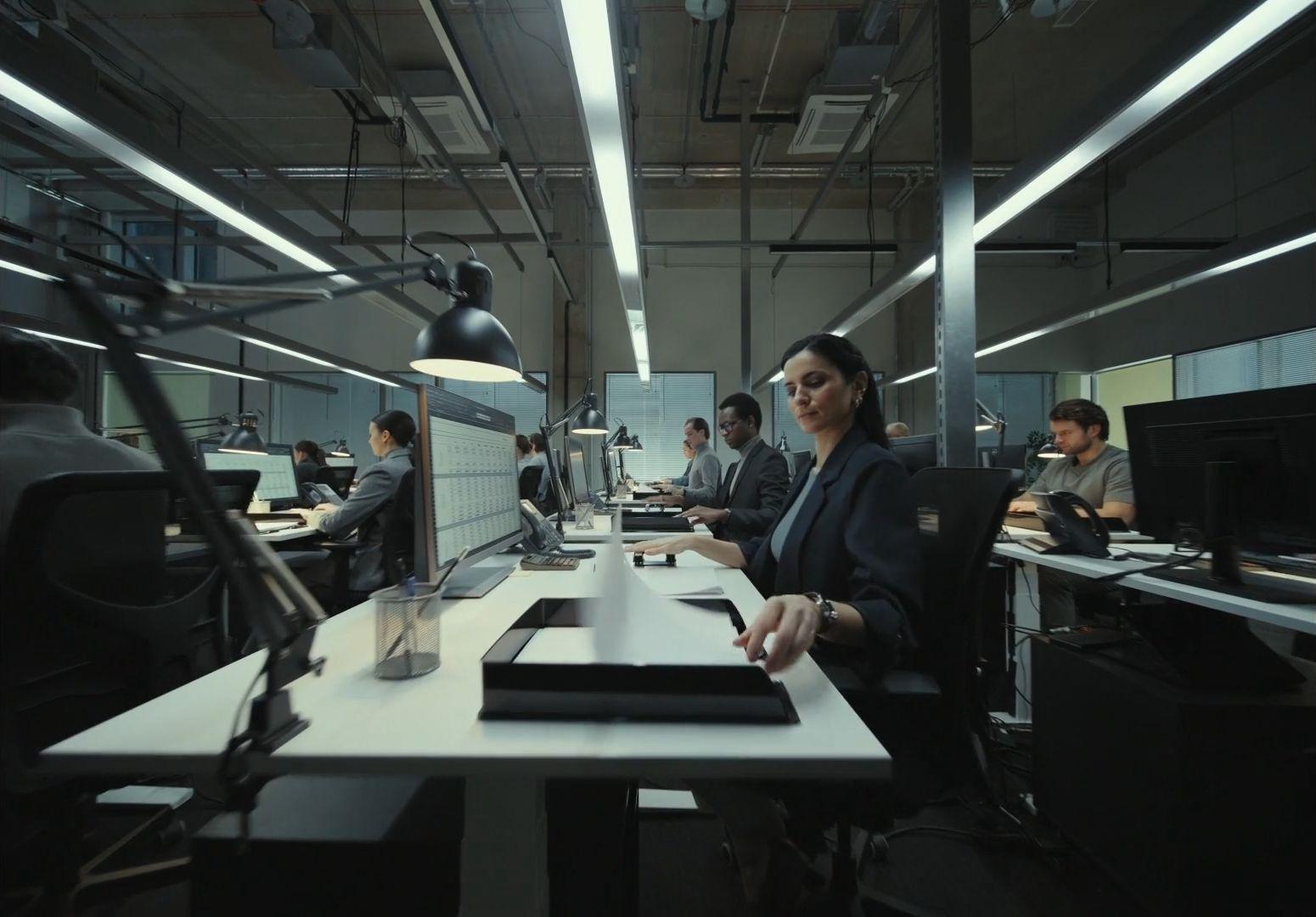 a woman sitting at a desk in an office