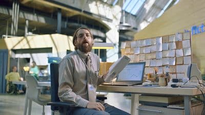 a man sitting at a desk with a laptop