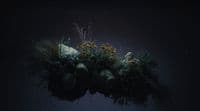 a vase filled with plants and rocks on a table