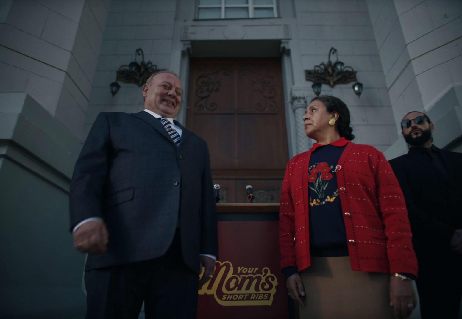 a man and a woman standing in front of a building
