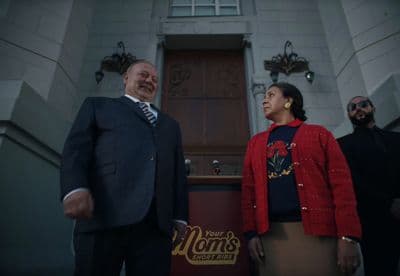 a man and a woman standing in front of a building