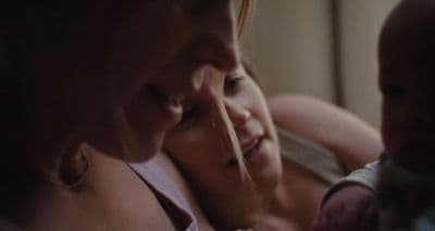 a woman holding a baby in her arms