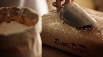 a person using a pastry cutter on a bag