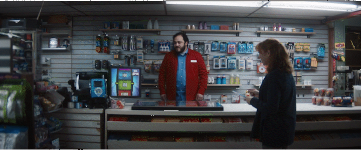 a man and a woman standing in front of a store counter