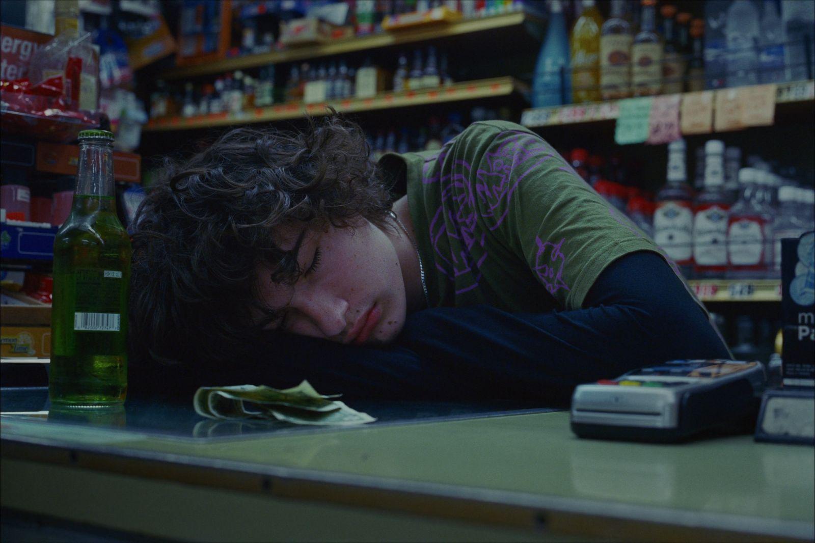 a woman laying her head on a counter in a store