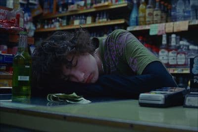 a woman laying her head on a counter in a store