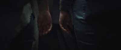 two people holding hands in the dark