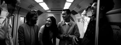a group of people standing on a subway train