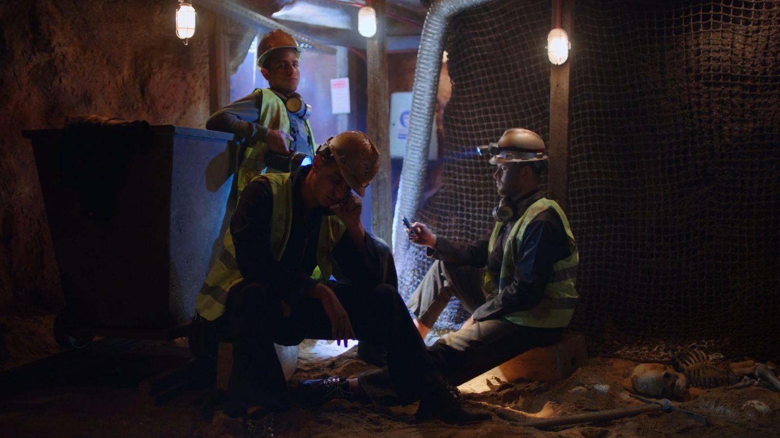 a group of men standing next to each other in a tunnel