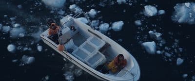 two people on a small boat in the water