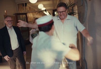 a group of men standing around each other in a room