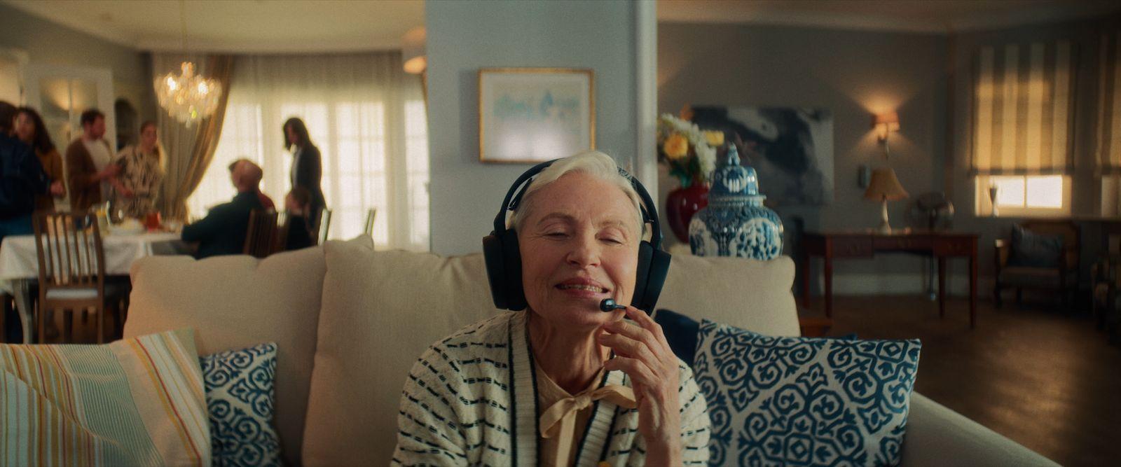a woman sitting on a couch with headphones on