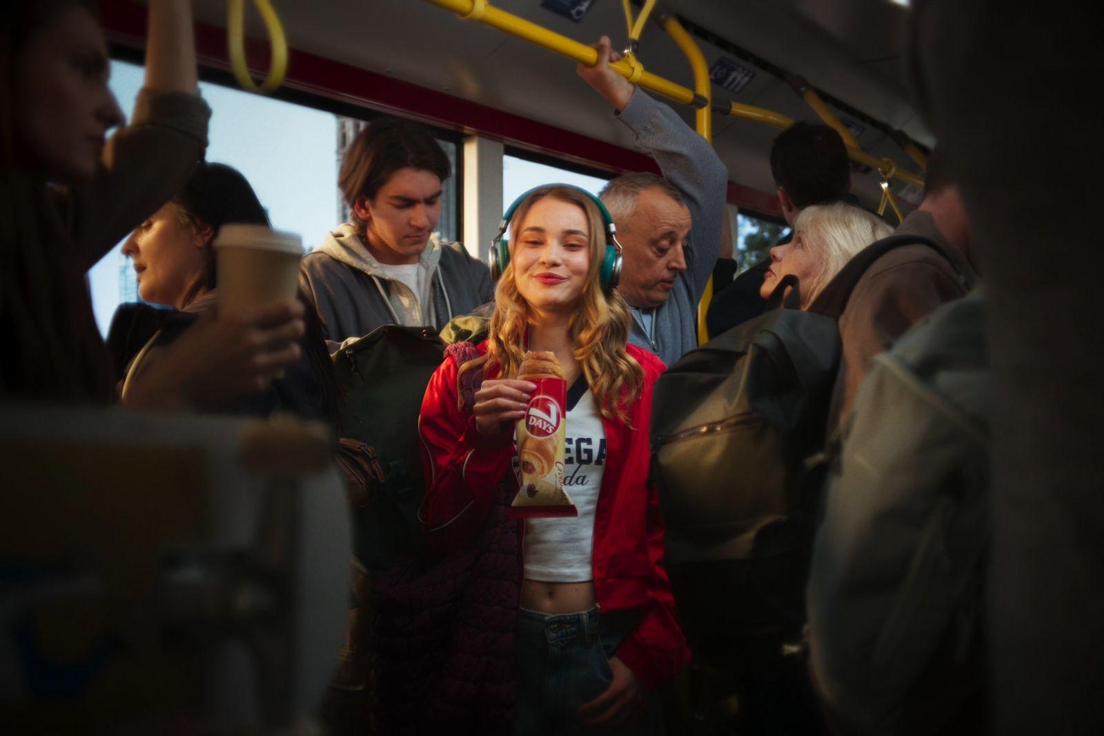 a group of people standing on a bus next to each other