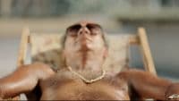 a man in a chair with his eyes closed