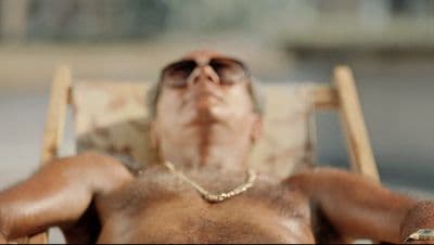a man in a chair with his eyes closed
