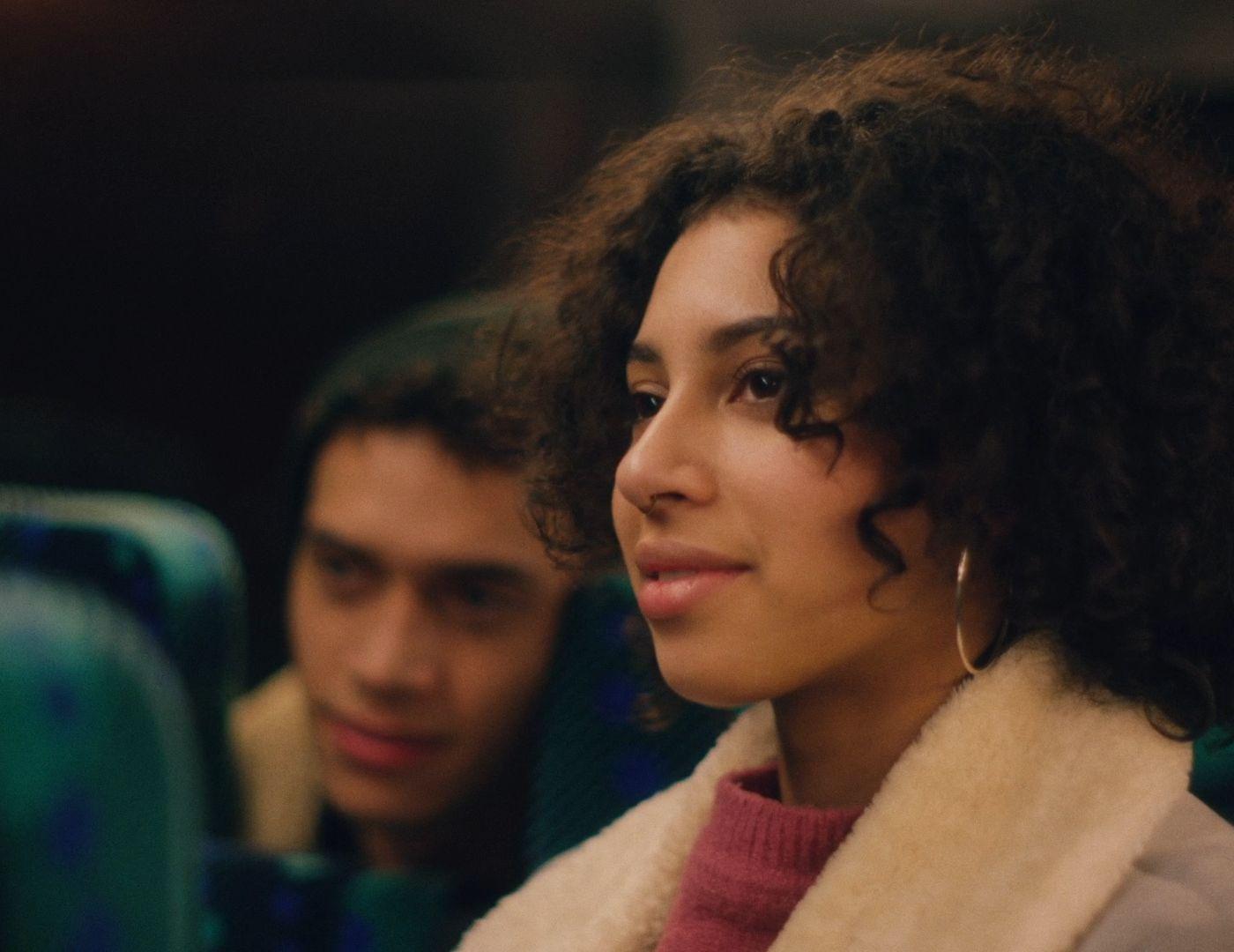 a close up of a person with curly hair