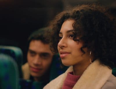 a close up of a person with curly hair