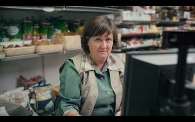a woman sitting in front of a computer in a store