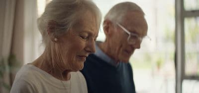 a man and a woman looking at a cell phone