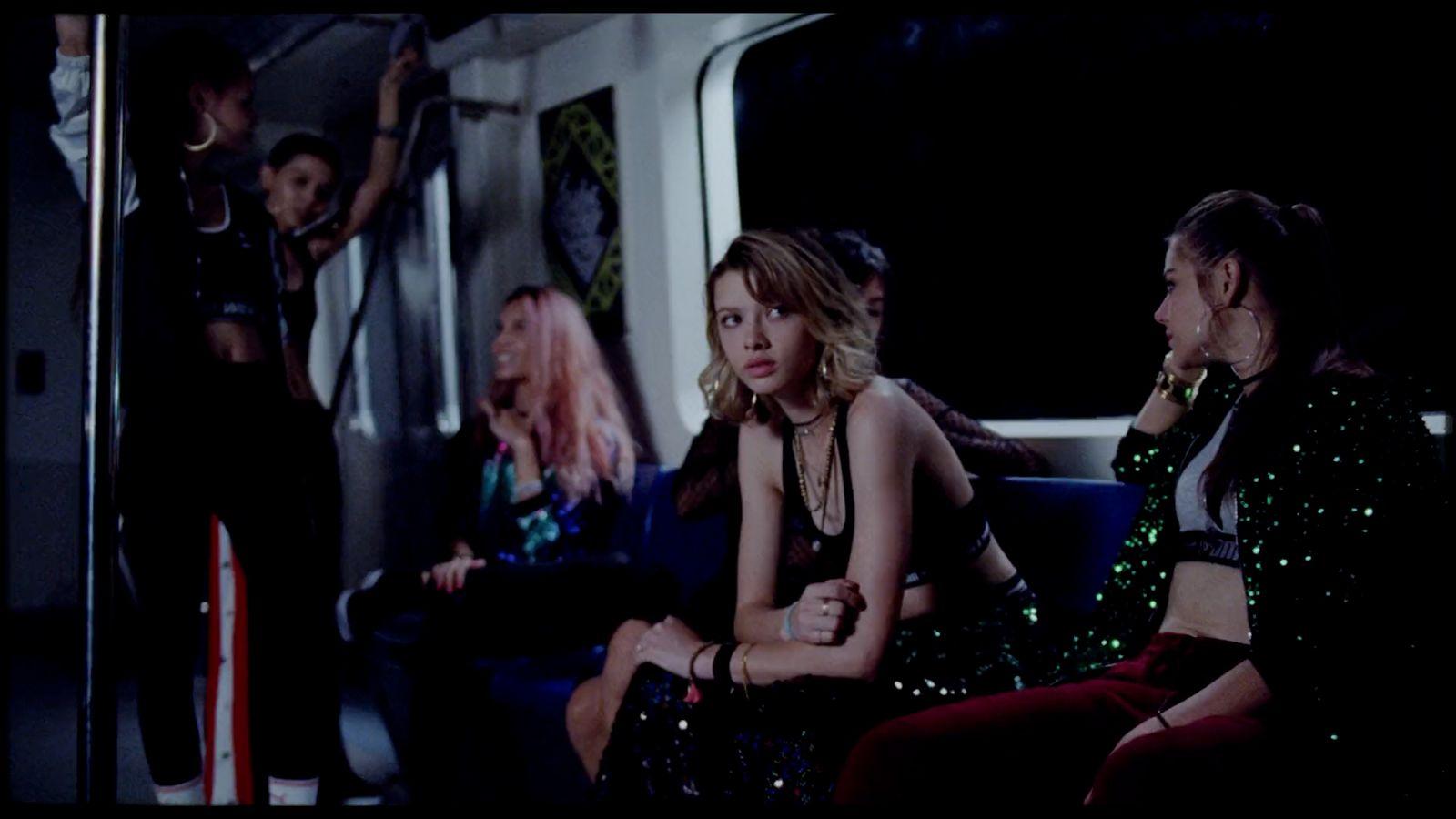a group of women sitting next to each other on a train