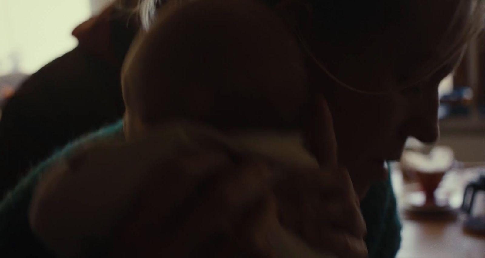 a woman holding a baby in her arms