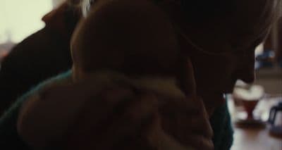 a woman holding a baby in her arms
