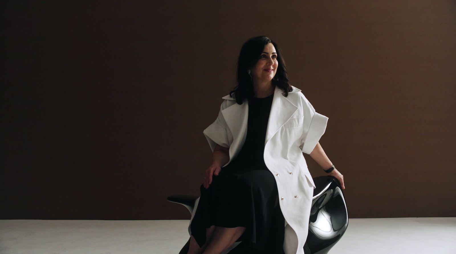 a woman sitting on a chair in a room
