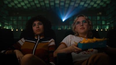 a couple of women sitting next to each other