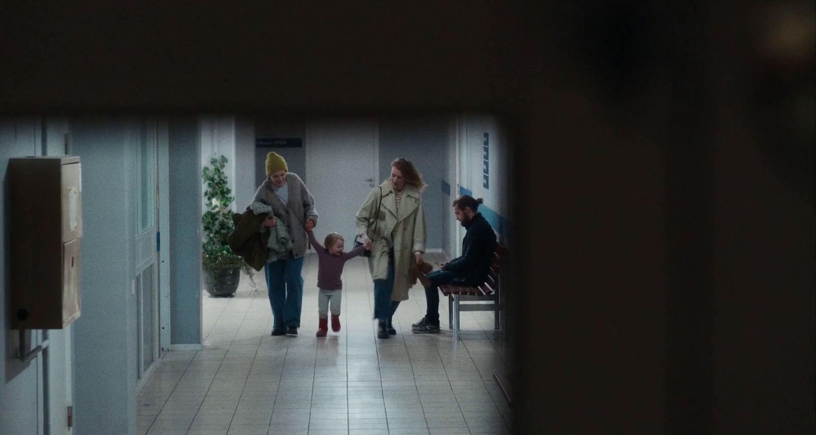 a group of people walking down a hallway
