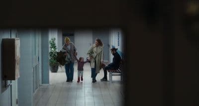 a group of people walking down a hallway