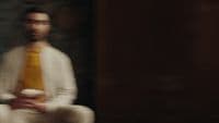 a blurry photo of a man wearing a yellow tie