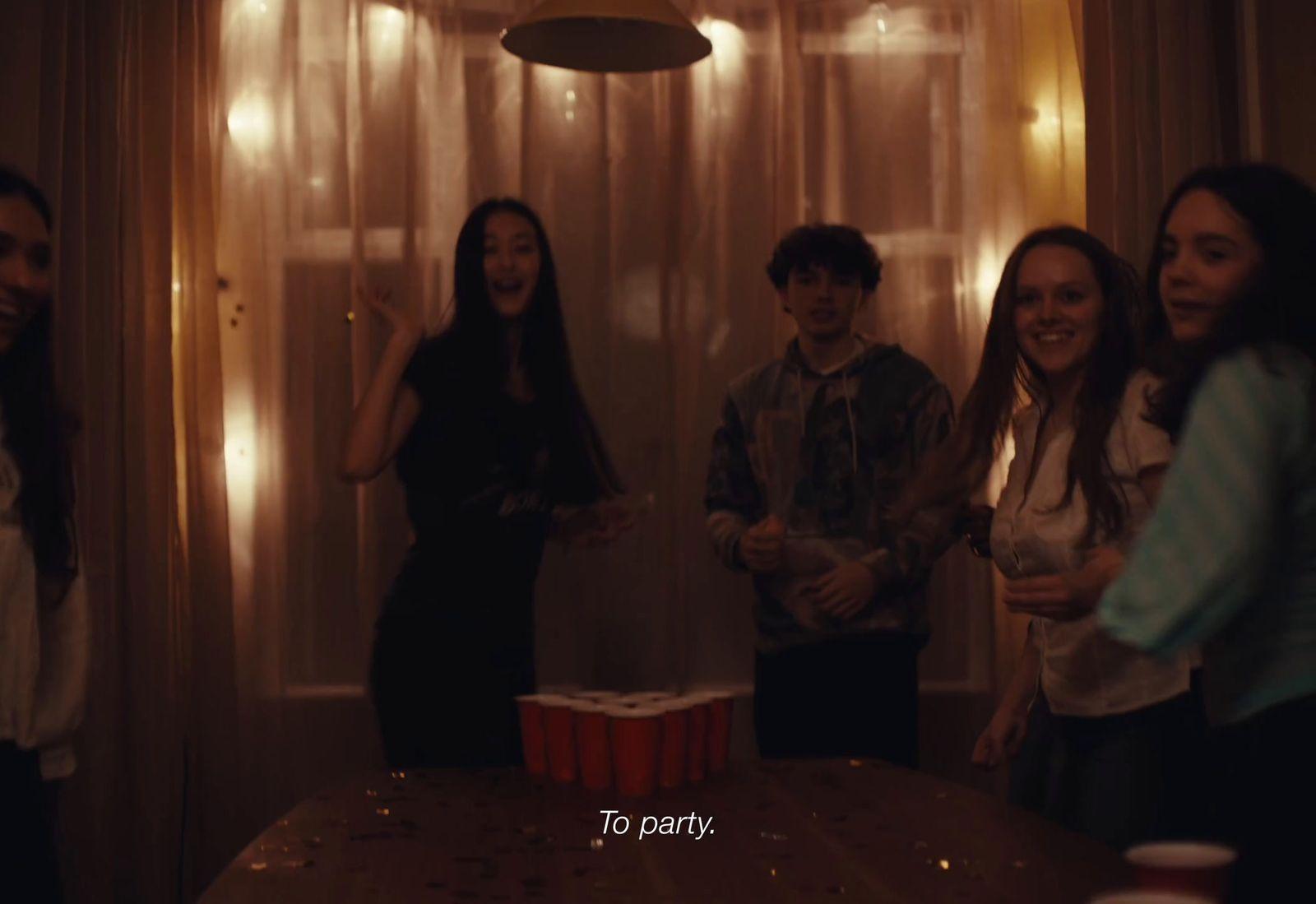 a group of people standing around a table