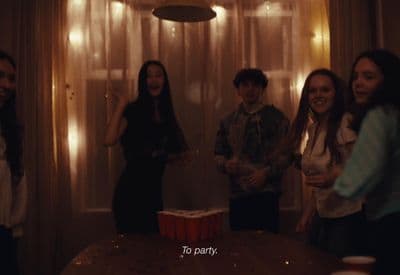 a group of people standing around a table