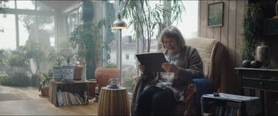 a woman sitting in a chair reading a book