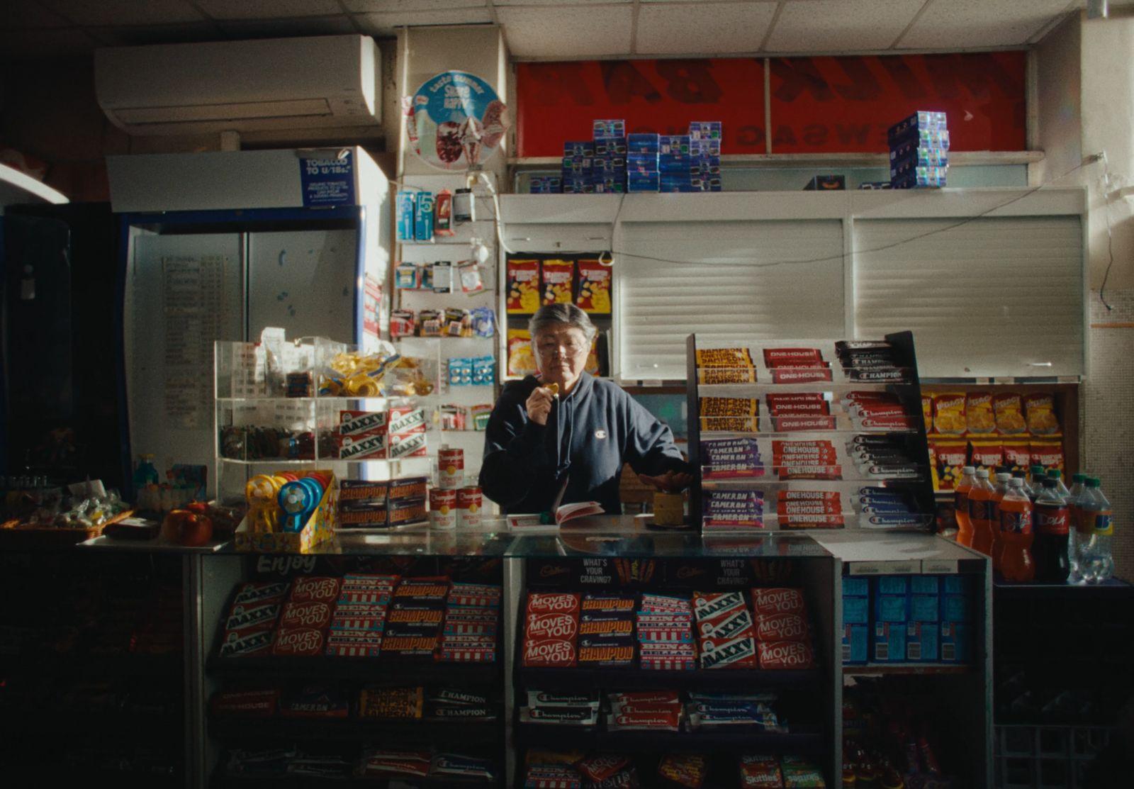 a man standing behind a counter in a store