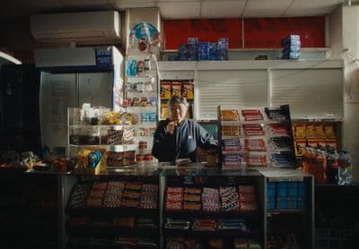 a man standing behind a counter in a store