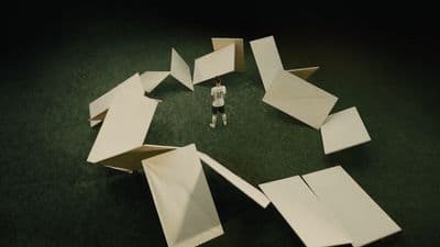 a person standing in front of a pile of paper