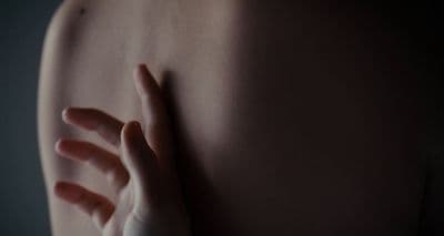 a woman's arm with a ring on it
