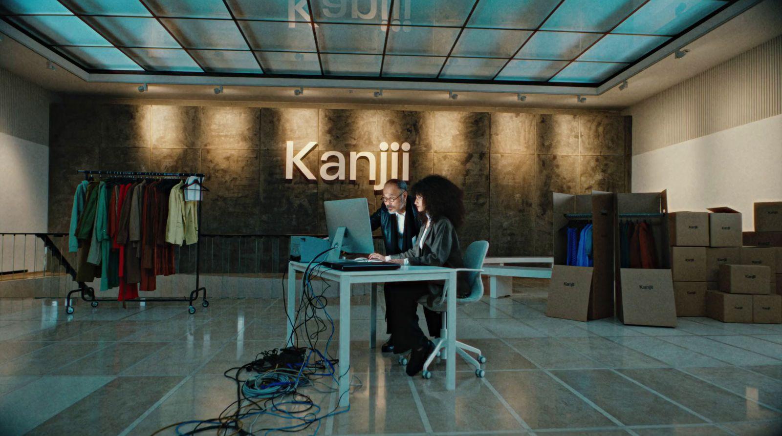 a woman sitting at a desk with a laptop