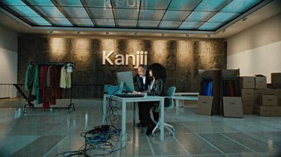 a woman sitting at a desk with a laptop