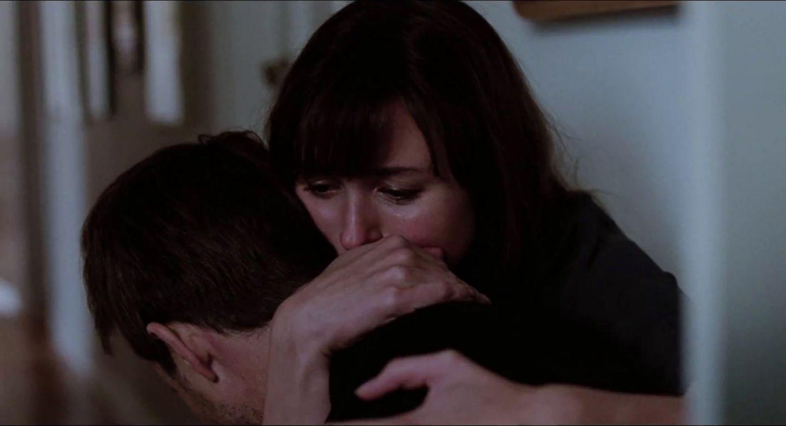 a man and a woman kissing in a room