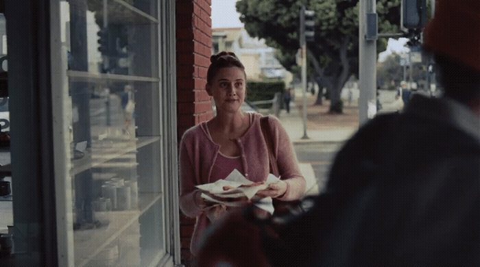 a woman sitting at a table with a plate of food