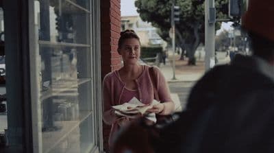a woman sitting at a table with a plate of food