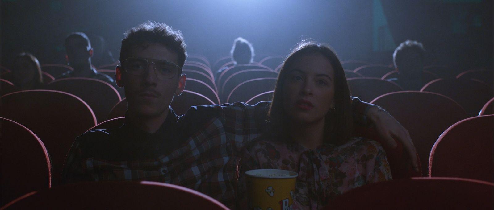 a man and a woman sitting in a movie theater