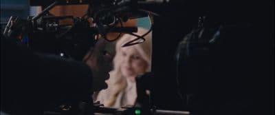 a woman standing in front of a camera