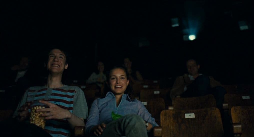 a couple of people that are sitting in a theater