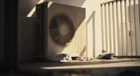 an air conditioner sitting on the side of a building