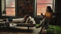 a man and a woman sitting on couches in a living room