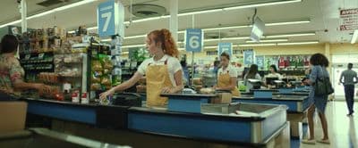 a woman standing at a counter in a store