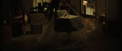 a person in a dark room with a plastic bag on the floor